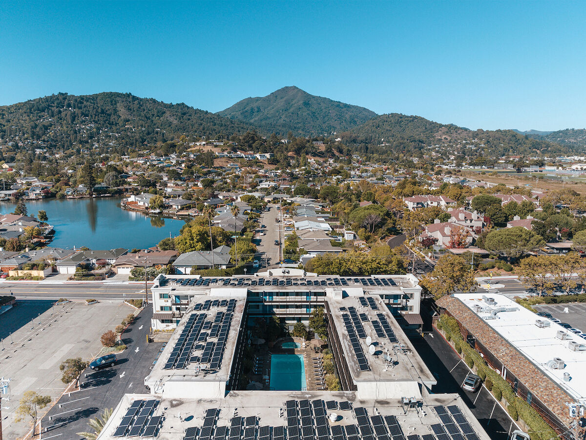 ariel view of marin suites courtyard pool and solar paneled roof